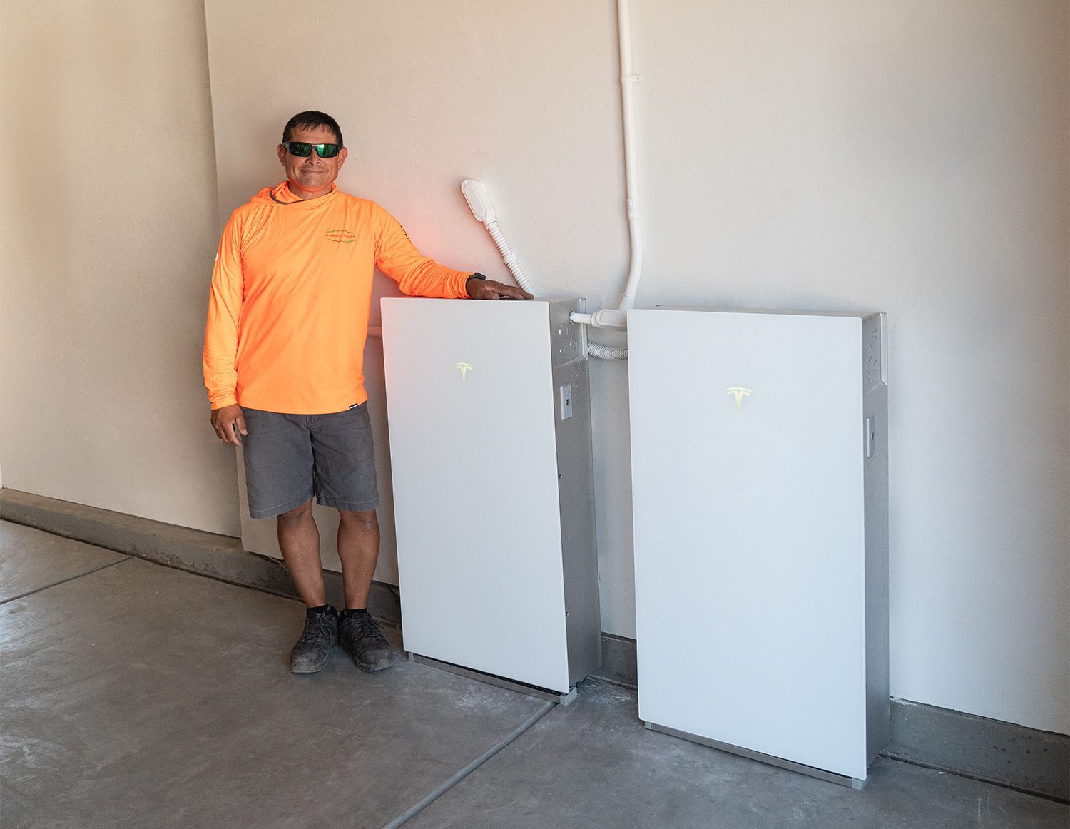 Tesla Powerwall 3 and our Synergy Power installer in a garage