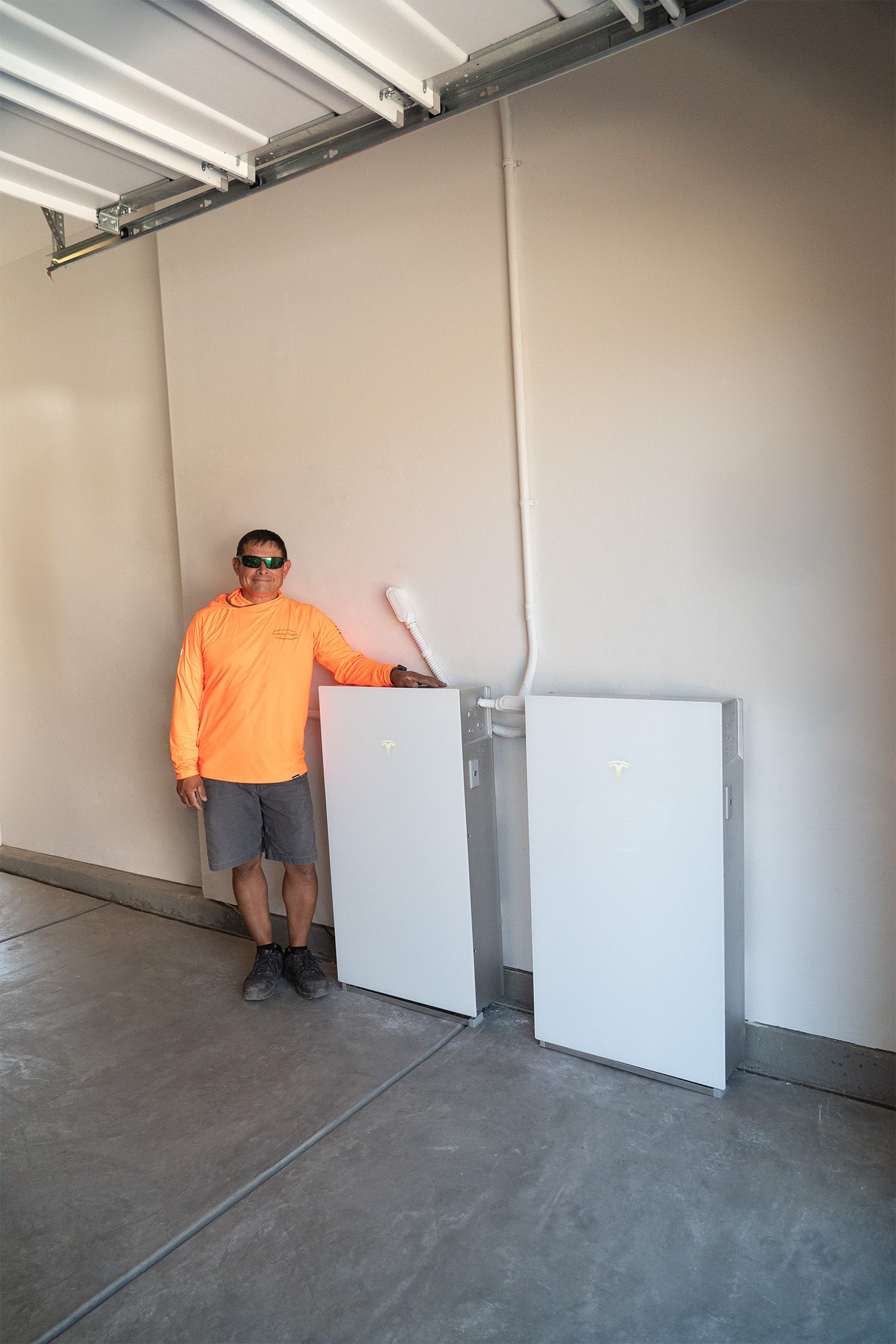 Tesla Powerwall 3 and our Synergy Power installer in a garage